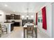 Bright dining area with modern light fixture, and view of kitchen and outdoor scenery at 6265 Sw 88Th Loop, Ocala, FL 34476