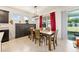 Contemporary dining area with tile floors, natural light, and stylish furniture at 6265 Sw 88Th Loop, Ocala, FL 34476