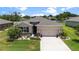 Charming home exterior with well-manicured landscaping and a spacious driveway at 6265 Sw 88Th Loop, Ocala, FL 34476