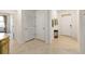 Bright foyer featuring tile flooring, white walls, and access to multiple rooms at 6265 Sw 88Th Loop, Ocala, FL 34476