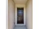 Elegant brown front door with stylish panels and a transom window, providing a warm and inviting entrance to the home at 6265 Sw 88Th Loop, Ocala, FL 34476