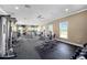 Spacious gym featuring various exercise equipment and natural light, providing a comfortable workout environment at 6265 Sw 88Th Loop, Ocala, FL 34476