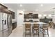 Kitchen featuring dark cabinets, stainless steel appliances, and a large granite island with seating at 6265 Sw 88Th Loop, Ocala, FL 34476