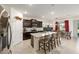 Open kitchen with granite island seating and dark cabinetry next to the dining area and living room at 6265 Sw 88Th Loop, Ocala, FL 34476