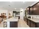 Modern kitchen featuring dark cabinets, stainless steel appliances, and granite countertops at 6265 Sw 88Th Loop, Ocala, FL 34476
