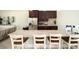 Well-lit kitchenette with stone countertops, stainless steel appliances, and stylish bar seating at 6265 Sw 88Th Loop, Ocala, FL 34476