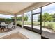 Screened lanai with neutral colors and furniture overlooking the well maintained backyard at 6265 Sw 88Th Loop, Ocala, FL 34476