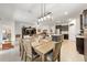 Open-concept living room with dining area and kitchen featuring dark cabinets and modern appliances at 6265 Sw 88Th Loop, Ocala, FL 34476