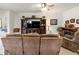 Inviting living room featuring a ceiling fan, media center, and tile flooring at 6265 Sw 88Th Loop, Ocala, FL 34476