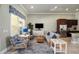 A bright lounge with modern furnishings, a TV, kitchenette, and stylish decor, creating a relaxing atmosphere at 6265 Sw 88Th Loop, Ocala, FL 34476