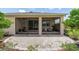 Back exterior view of the house with a screened lanai and paved patio area at 6265 Sw 88Th Loop, Ocala, FL 34476