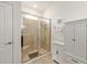 Glass-enclosed shower with tiled walls, a built-in seat and tiled floors in a well-appointed bathroom at 6265 Sw 88Th Loop, Ocala, FL 34476