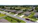 Aerial view of single-Gathering homes featuring well-kept lawns, landscaping and quiet residential street at 6265 Sw 88Th Loop, Ocala, FL 34476