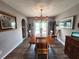 Traditional dining room with a wooden table, stylish lighting, and views to an outdoor pool at 6312 Sw 60Th Ct, Ocala, FL 34474