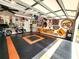 Spacious garage featuring durable flooring, a motorcycle, and decorated with nostalgic signs and artwork at 6312 Sw 60Th Ct, Ocala, FL 34474