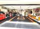 Spacious garage with room for multiple vehicles, a workbench, and ample storage at 6312 Sw 60Th Ct, Ocala, FL 34474