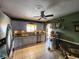 Well-lit kitchen featuring updated appliances, tiled floors, and decorative hanging pot rack at 6312 Sw 60Th Ct, Ocala, FL 34474