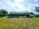 Expansive lawn features a well-manicured hedge surrounding a large screened-in lanai at 6312 Sw 60Th Ct, Ocala, FL 34474