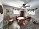 Comfortable living room boasting wood floors, ceiling fan, and charming vintage furniture at 6312 Sw 60Th Ct, Ocala, FL 34474