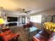 Cozy living room with hard wood floors, ceiling fan, flat screen TV, and lots of comfy seating at 6312 Sw 60Th Ct, Ocala, FL 34474