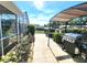 Outdoor living space featuring a built-in grill, lanai, and shaded dining area at 6312 Sw 60Th Ct, Ocala, FL 34474