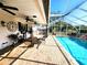 Covered patio with an in-ground swimming pool, an outdoor dining area, and brick paver flooring at 6312 Sw 60Th Ct, Ocala, FL 34474