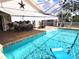 Screened pool with covered patio area, brick flooring, and awning, creating a perfect outdoor retreat at 6312 Sw 60Th Ct, Ocala, FL 34474