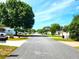 Picturesque street view showcasing a quiet neighborhood with mature trees and well-maintained lawns under a blue sky at 6312 Sw 60Th Ct, Ocala, FL 34474