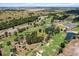 A picturesque aerial view showcases a golf course with lush greenery, sand traps, and scenic fairways at 6680 Sw 179Th Court Rd, Dunnellon, FL 34432