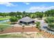 Stunning aerial view of community clubhouse with golf course and beautifully manicured landscaping at 6680 Sw 179Th Court Rd, Dunnellon, FL 34432