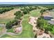 Scenic aerial showcasing golf course, sand traps, and meticulous landscape design in a desirable community at 6680 Sw 179Th Court Rd, Dunnellon, FL 34432