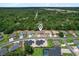 Aerial view of a residential neighborhood featuring well-manicured lawns and mature trees at 6680 Sw 179Th Court Rd, Dunnellon, FL 34432