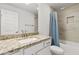Modern bathroom featuring granite counters, a new tile surround in the tub and a white vanity at 6680 Sw 179Th Court Rd, Dunnellon, FL 34432