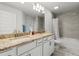 Bright bathroom showcasing a double vanity, granite counters and bathtub with a tile surround at 6680 Sw 179Th Court Rd, Dunnellon, FL 34432