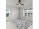Bedroom featuring tiled floors, two windows with blinds, and a unique ceiling fan at 6680 Sw 179Th Court Rd, Dunnellon, FL 34432