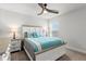 Relaxing bedroom featuring large windows, a ceiling fan, carpet floors and an abundance of natural light at 6680 Sw 179Th Court Rd, Dunnellon, FL 34432