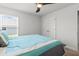 Inviting bedroom with a ceiling fan, a double door closet and natural light from a large window at 6680 Sw 179Th Court Rd, Dunnellon, FL 34432