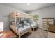 Shared bedroom showcasing bunkbeds, a large window and a dresser with plenty of storage space at 6680 Sw 179Th Court Rd, Dunnellon, FL 34432