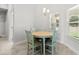 Cozy dining area featuring a round wooden table and bright window views at 6680 Sw 179Th Court Rd, Dunnellon, FL 34432