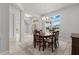 Bright dining room with natural light, chandelier and dining table, located next to the entry at 6680 Sw 179Th Court Rd, Dunnellon, FL 34432