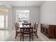 Dining room features a chandelier, a dining table, and a beautiful window for natural light at 6680 Sw 179Th Court Rd, Dunnellon, FL 34432