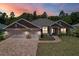Charming single-story home featuring a three-car garage, brick driveway, and well-maintained landscaping at 6680 Sw 179Th Court Rd, Dunnellon, FL 34432