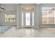 Bright foyer featuring decorative tile flooring, transom windows, and neutral paint colors at 6680 Sw 179Th Court Rd, Dunnellon, FL 34432