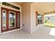 Close-up of a decorative front door with sidelights and a window, situated on a covered porch at 6680 Sw 179Th Court Rd, Dunnellon, FL 34432