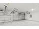 Spacious garage with multiple bay doors and automatic openers, and a high ceiling at 6680 Sw 179Th Court Rd, Dunnellon, FL 34432