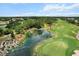 Picturesque golf course aerial featuring a scenic pond, lush landscaping, and expertly designed course layout at 6680 Sw 179Th Court Rd, Dunnellon, FL 34432