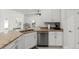 Bright kitchen featuring stainless steel appliances, granite countertops, and white cabinetry at 6680 Sw 179Th Court Rd, Dunnellon, FL 34432