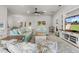 Bright living room with tile floors, a ceiling fan, and views of the kitchen and dining room at 6680 Sw 179Th Court Rd, Dunnellon, FL 34432