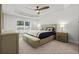 Main bedroom boasts trey ceilings, a ceiling fan, and large window for natural light at 6680 Sw 179Th Court Rd, Dunnellon, FL 34432
