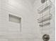 Close up on the shower details: built in shelf and a toiletry storage rack at 6680 Sw 179Th Court Rd, Dunnellon, FL 34432